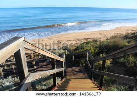 Wooden steps leading down to the ocean at Mangles Beach Bunbury Western Australia on a calm  early winter morning.