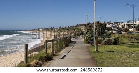 Panoramic view of the Indian Ocean from the cycle way  at  Ocean beach Bunbury Western Australia on a sunny afternoon in summer  shows waves breaking on the sandy shore.