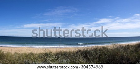 Panorama of the  vegetated dunes and Indian Ocean at Ocean Beach  Bunbury south western Australia on a sunny afternoon in late winter   is cool and inviting.