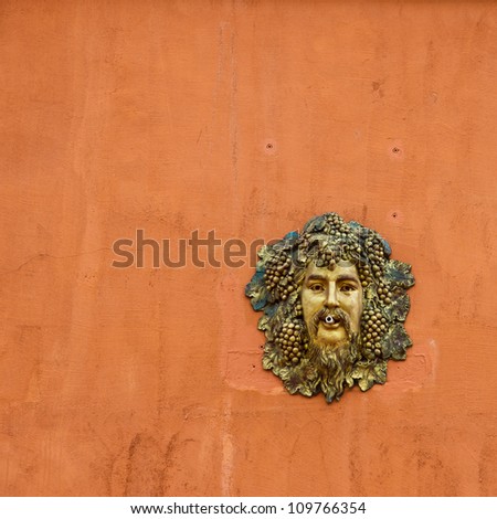 cast metal face man head on the orange wall