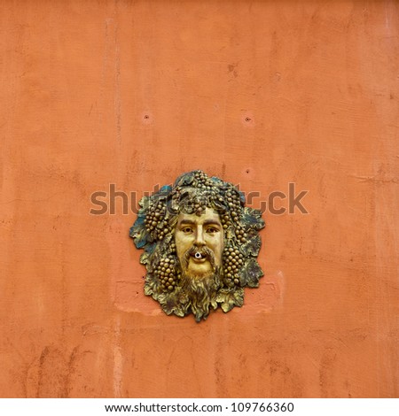 cast metal face man head on the orange wall