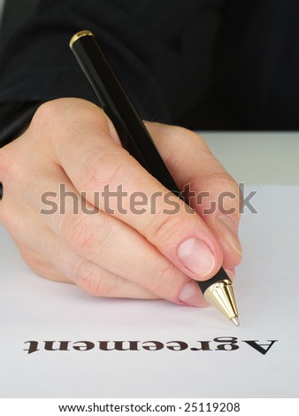 Hand signing agreement document. See more like it in my portfolio.