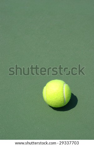 Tennis ball on green hard surface. See more tennis images in my portfolio.