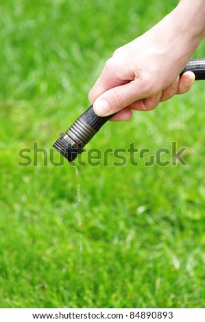 Water coming out of hose in hand