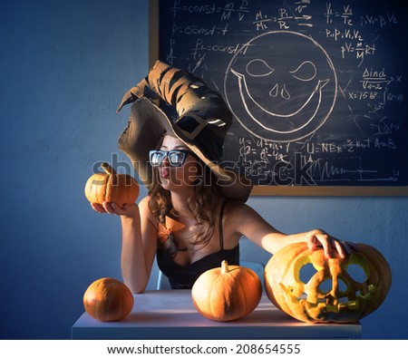 In the class witch sitting at the table with pumpkin