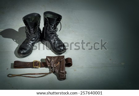 Military gun, belt, boots with high ankle boots