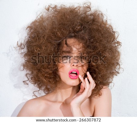 Girl with lush hair and bright lipstick