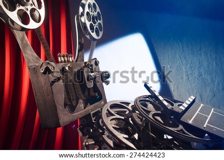 http://image.shutterstock.com/display_pic_with_logo/95479/274424423/stock-photo-film-projector-projecting-a-movie-on-the-wall-274424423.jpg