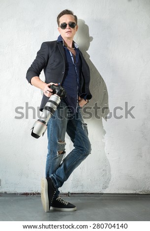 Photographer with a camera and a telephoto lens