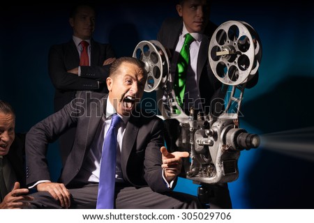 One and the same person looks at a vintage comedy movie projector