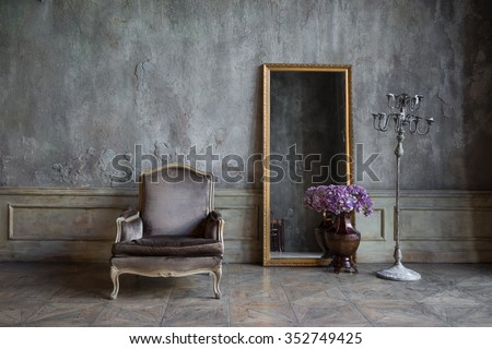 In the room are antique mirror and a chair
