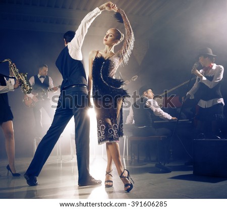 Dance couple dancing to a live band sounds