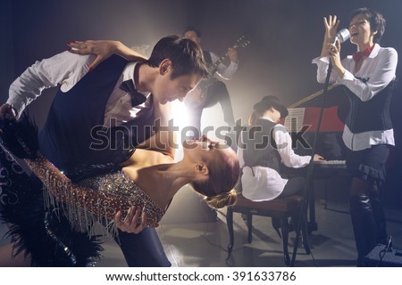 Dancing couple on background jazz orchestra