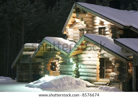 Highlighted wooden house in the forest at night