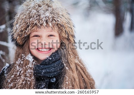 winter outdoor portrait of beautiful happy child girl