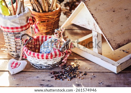 bird feeder and seeds in basket in country house in spring