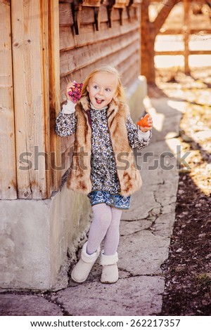 cute happy child girl with handmade chicken for easter at country house