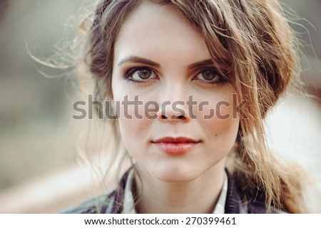 outdoor close up portrait of beautiful young woman