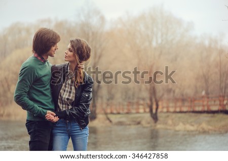 loving couple happy together outdoor on  rainy walk on country side, cozy mood