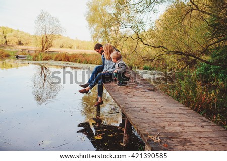 happy family spending time together outdoor. Lifestyle capture, rural cozy scene. Father, mother and son walking in forest