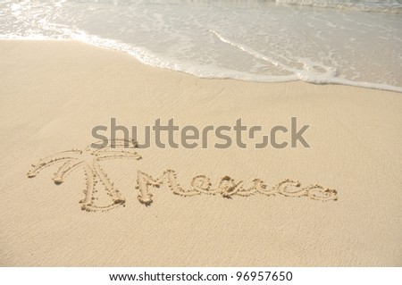 The Word Mexico and a Palm Tree Drawn in Sand on Beach