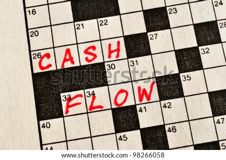 The Words Cash Flow on Crossword Puzzle in Red Ink, Copy Space