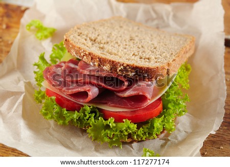 fresh deli sandwich with tomatoes, swiss cheese, lettuce