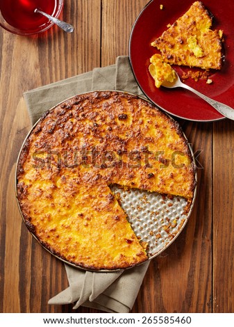 cheese cake in a baking tin and a pie slice on plate