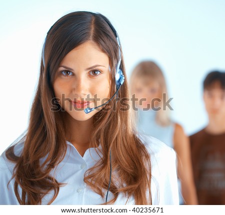 Young beautiful woman with headset with some people at the background