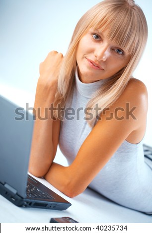Close-up portrait of a woman line on the floor with notebook and mobile