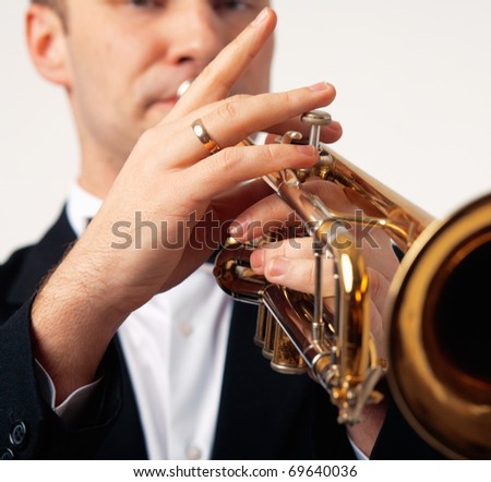 Closeup of the hands of an European musician playing the trumpet