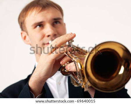 Closeup of the hands of an European musician playing the trumpet