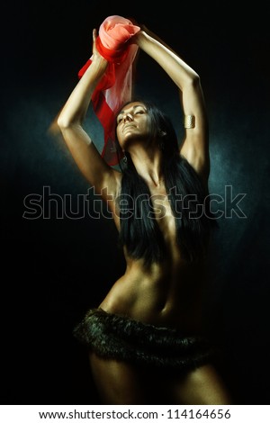 Bronze tanned latin girl wearing fell and dancing with red scarf