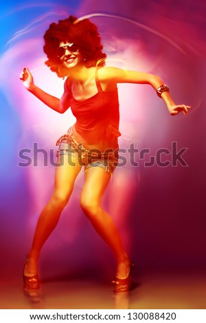 Sexy woman with afro haircut is dancing disco. Disco 80 style.