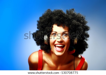 Happy woman with afro hairstyle wear headphones