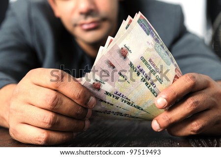 Egyptian man counting money in Egyptian currency