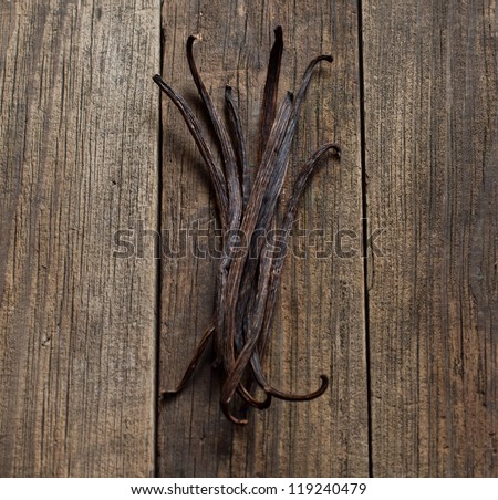 Vanilla sticks on the wood background