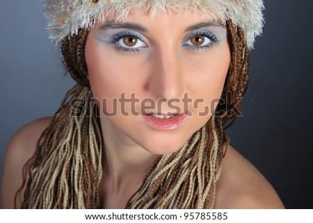 The person of the young beautiful girl with the big brown eyes, on a head a white cap