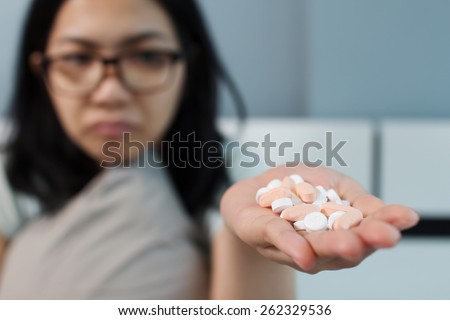 Asian girl sorrow and she don\'t like taking medicines.