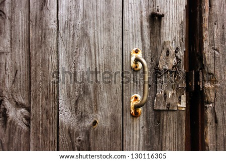 Old natural wooden texture with door handle. Broken door lock.