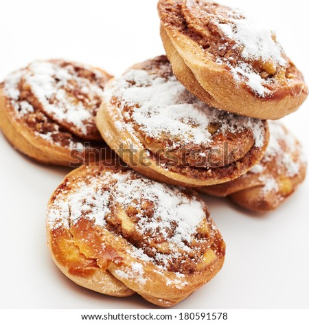 Buns with cinnamon on white background. Sweet rolls with sugar powder.