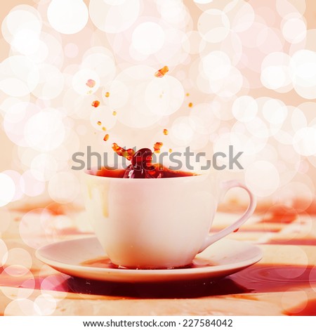 Cup of spilling coffee creating beautiful splash with stains on white. Coffee break, breakfast concept. Instagram effect with bokeh lights.