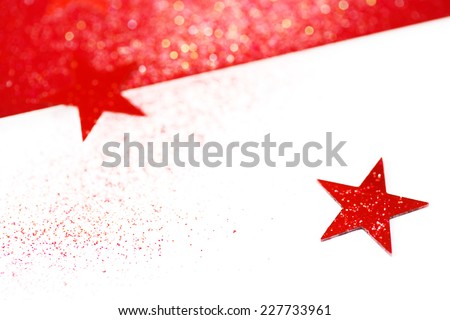 Holiday greeting card. Blurred Christmas background with stars. Red and white traditional colors, Selective focus, space for your text.