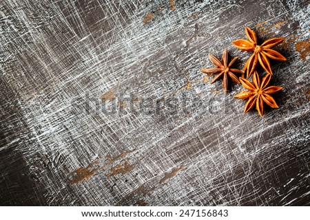 Food background with three star anise close up on vintage black table. Selective focus. Space for text, menu, recipe.
