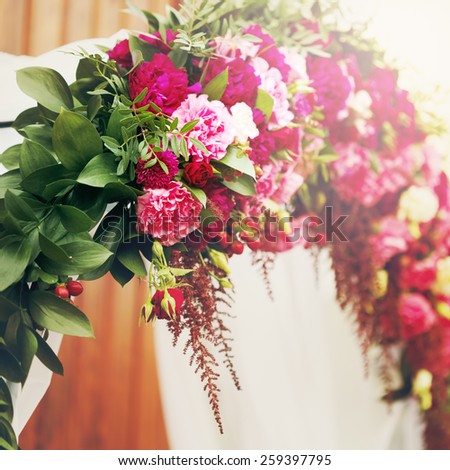 Flower decoration in wedding day. Pink, red and white roses and peony. Instagram color effect.