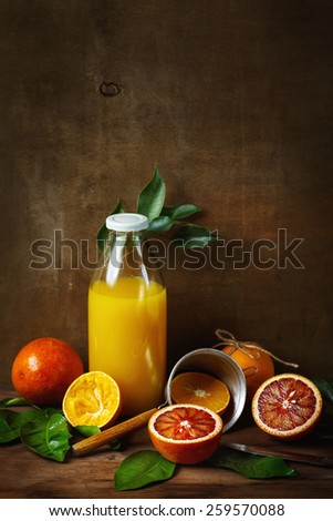 Still life with orange fruit and juice on wooden table. Painting style. Selective focus. Space for your text.