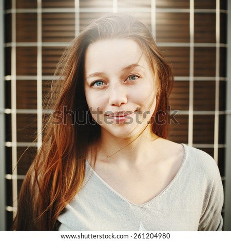 Young beautiful redhair female with deep blue eyes smiling. Instagram color style. Selective focus.