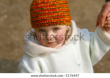 Little girl in winter clothes take granny\'s hand