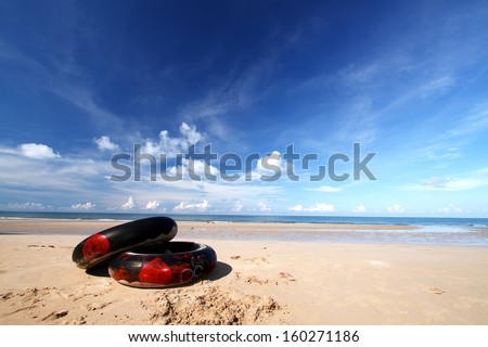 Black swim ring on the beach