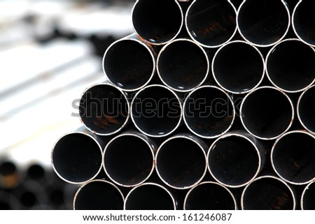 Rust steel pipes bunch on the rack in warehouse